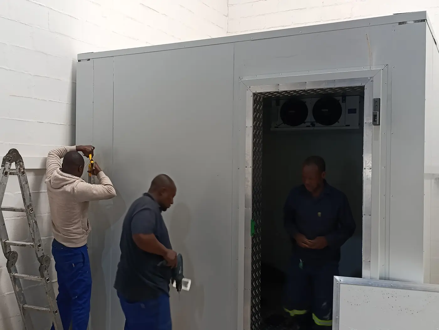 Technicians installing a commercial walk in freezer with 150mm insulated panels for Better Batters in Parow Industria, Cape Town.