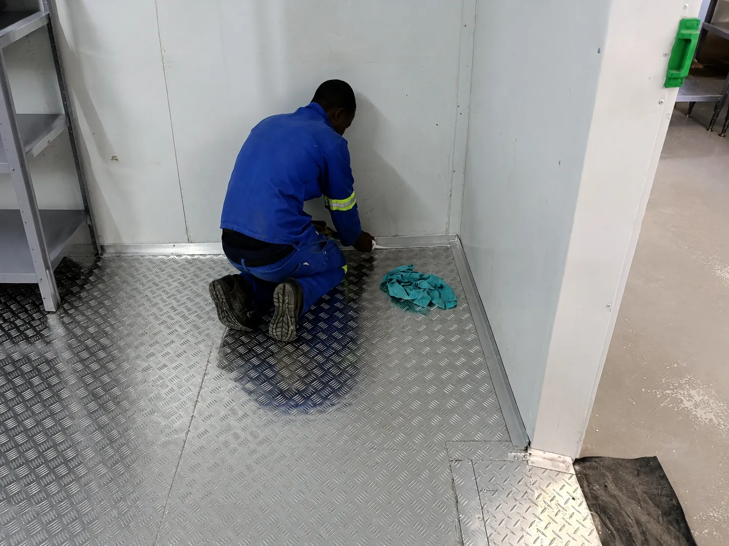 Technician completing aluminium floor edging inside the Bruce Catering walk-in cold room