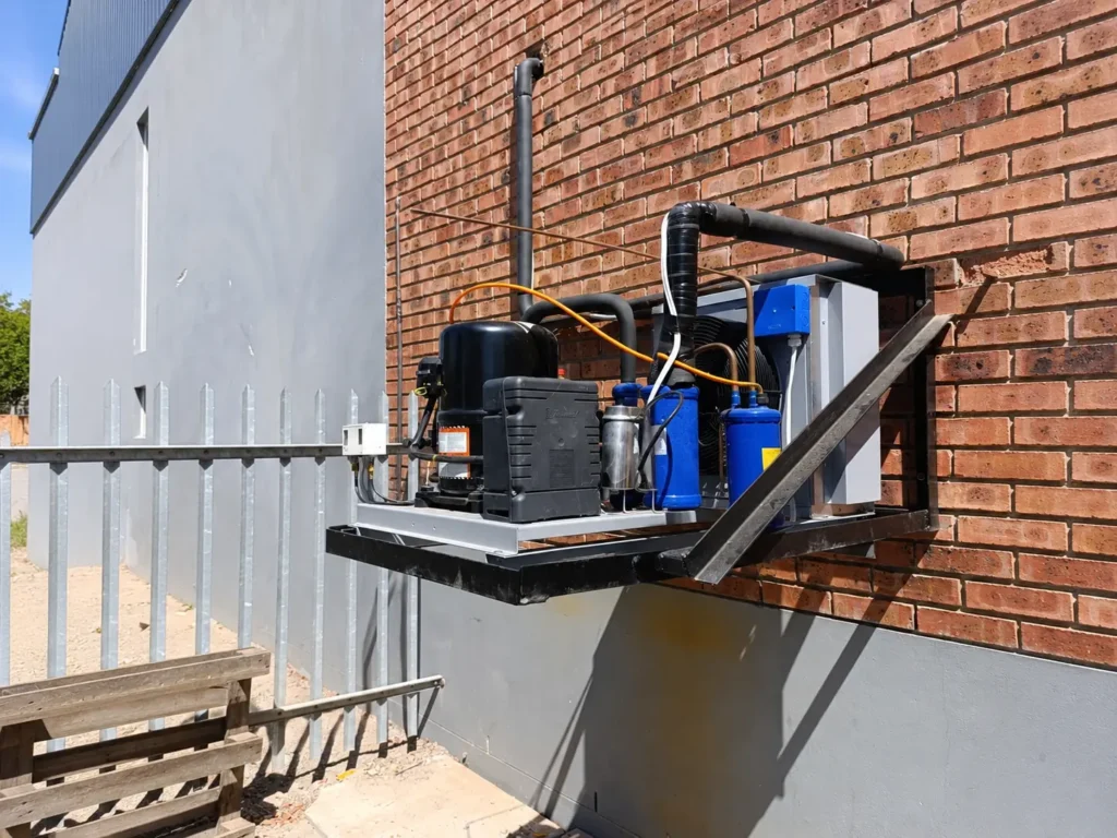 Commercial cold room condensing unit installed on an exterior wall