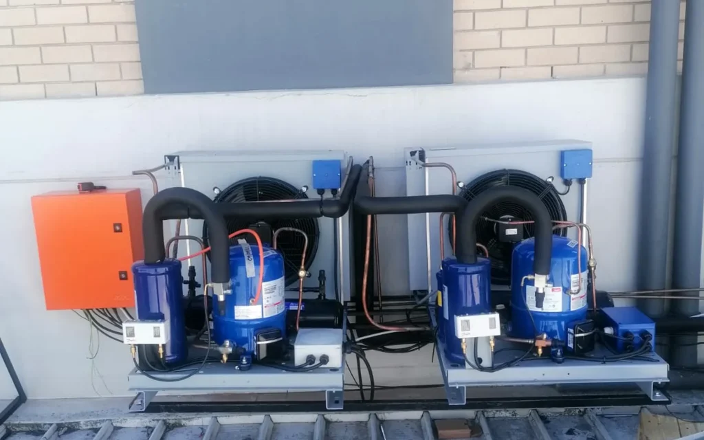 Twin commercial refrigeration condensing units installed on a rooftop