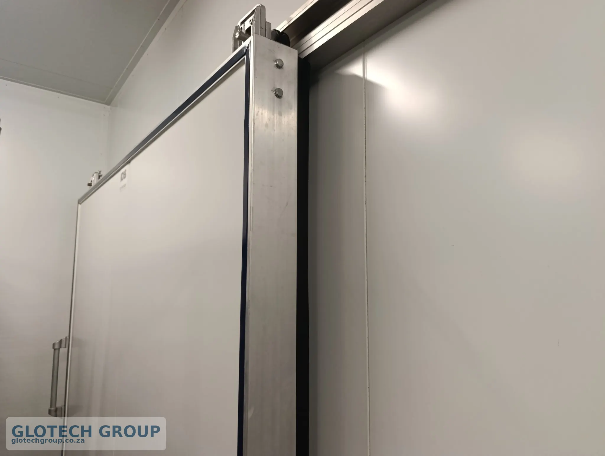 Close-up of the insulated cold room sliding door and seal.