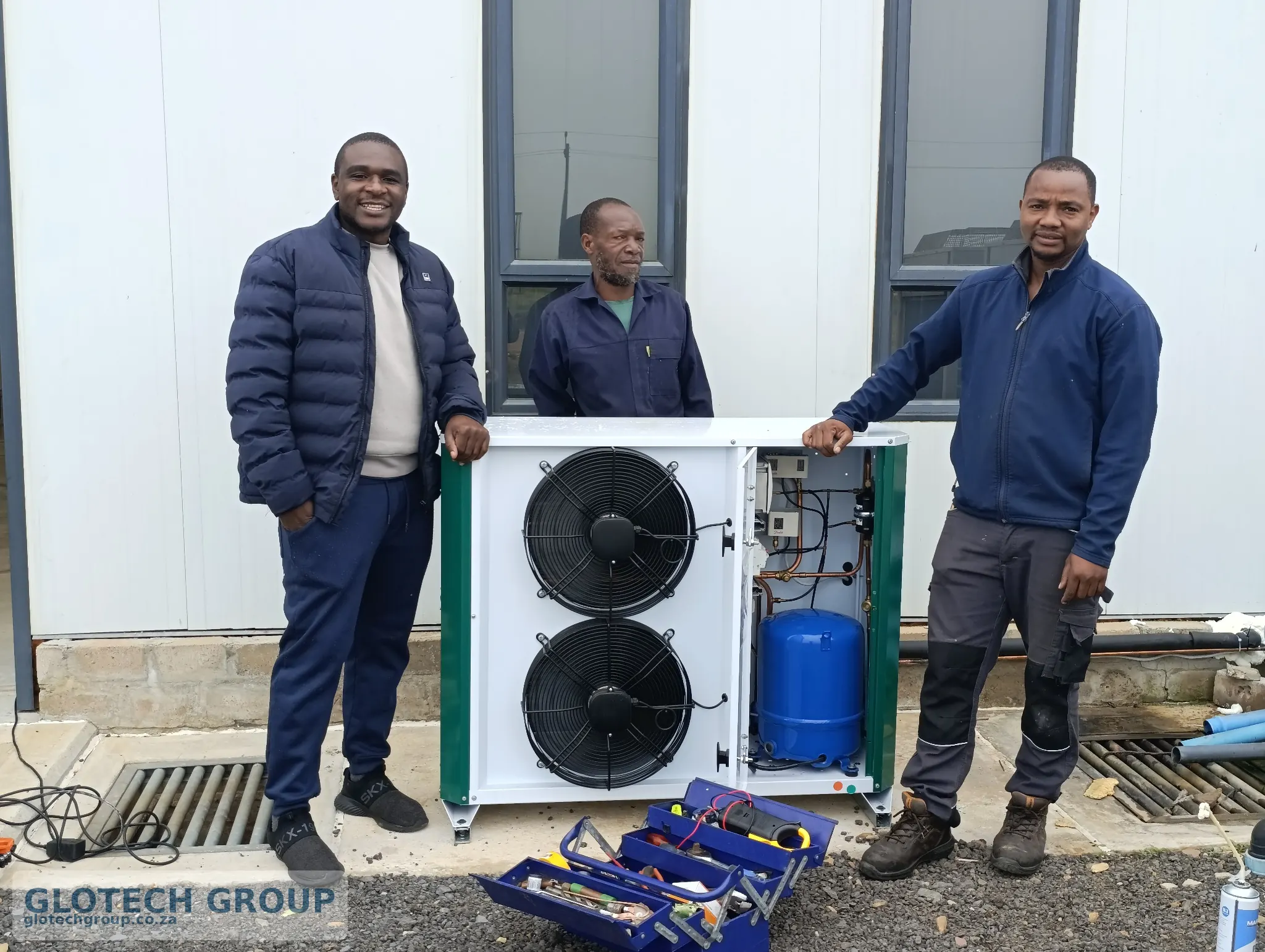 Glotech Group refrigeration team with the new condensing unit at Fall Creek Nursery.