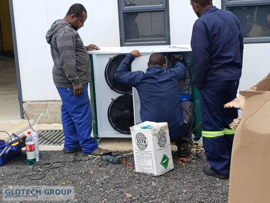 Technicians commissioning the cold room refrigeration unit at Fall Creek Nursery.