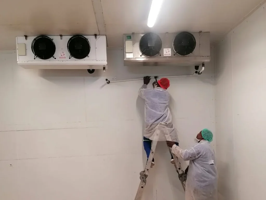 Refrigeration technicians installing blast freezer evaporators at Food Directions