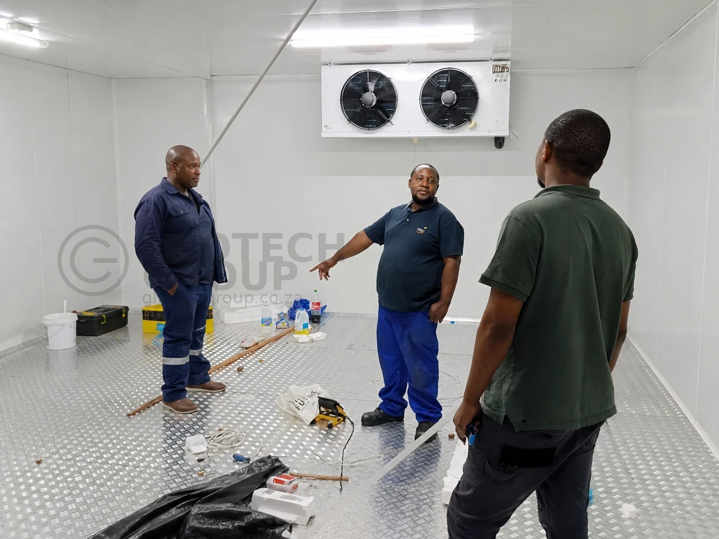 Team discussion inside the Popco Ice Cream walk in freezer during installation handover