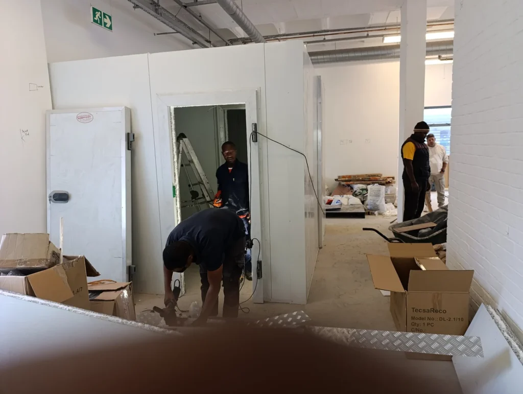 Installation team constructing a walk-in cold room at Sable Square in Milnerton