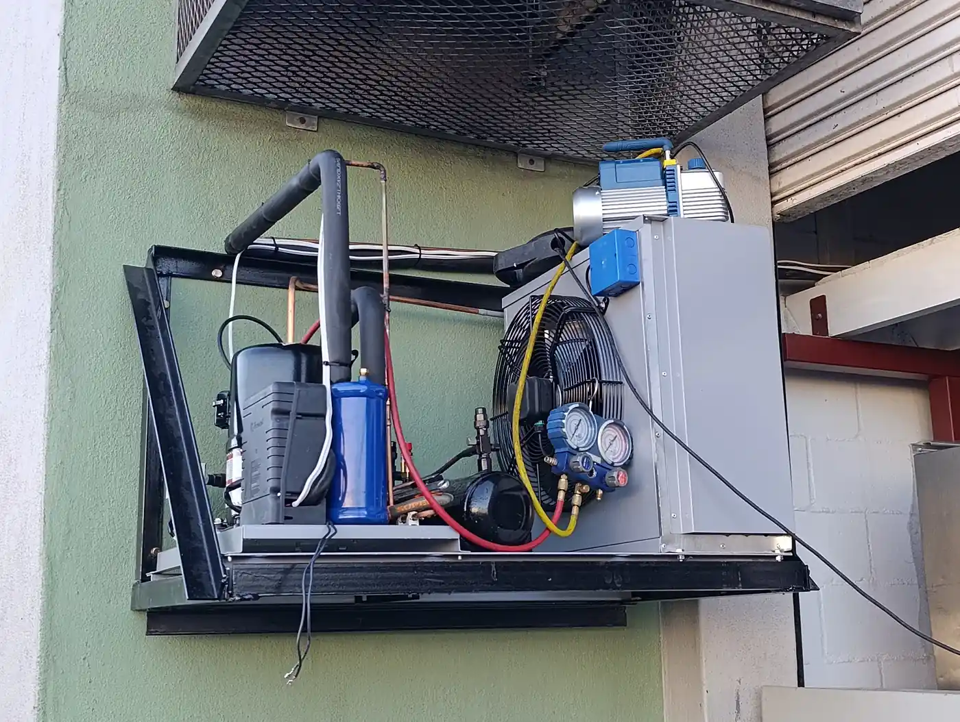 Vacuum testing commercial refrigeration system before refrigerant charging during walk in freezer installation.