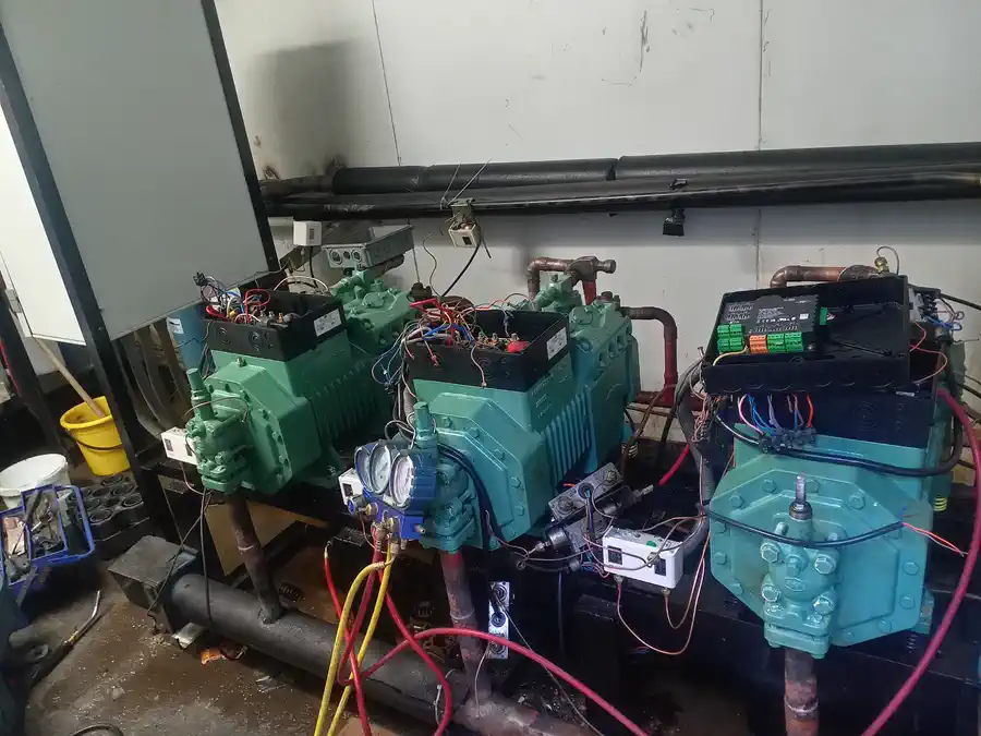 Three Bitzer compressors being connected during the Multiflex upgrade