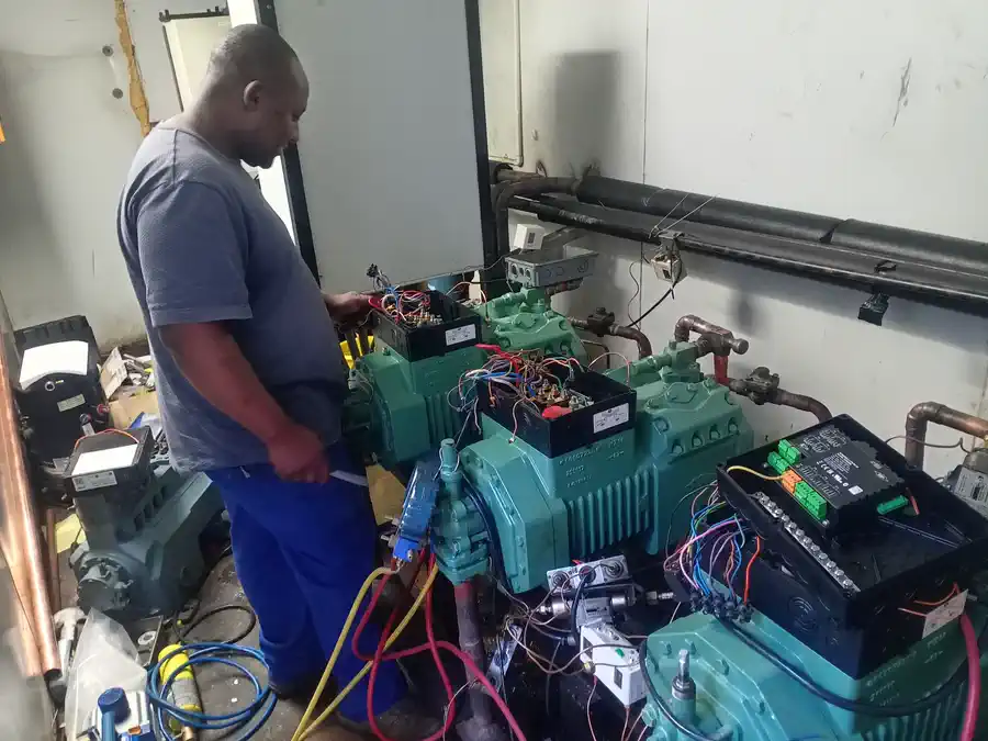 Technician testing newly installed Bitzer refrigeration compressors